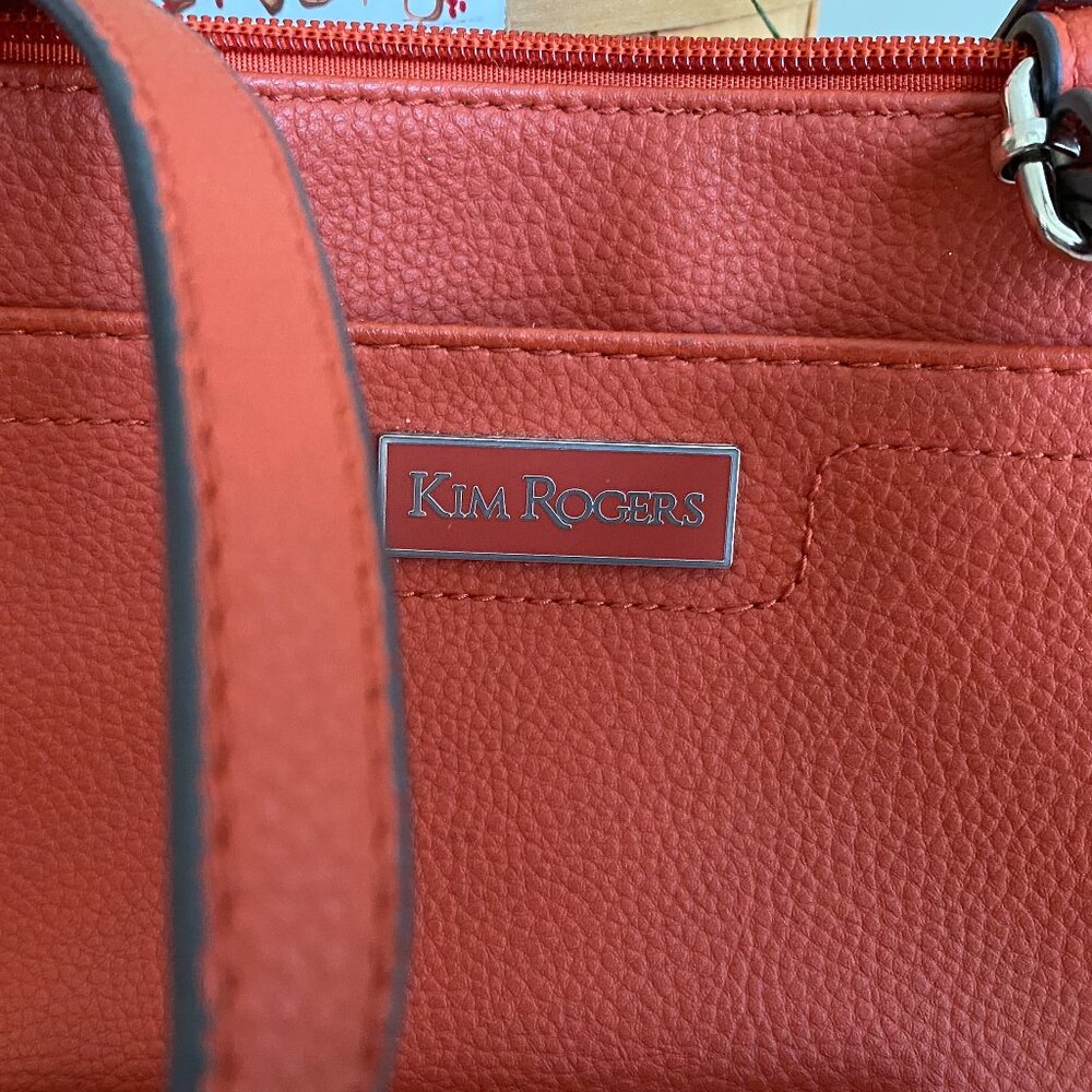 Gently used one time. Rust color both zipper top and snap closed bag w/strap